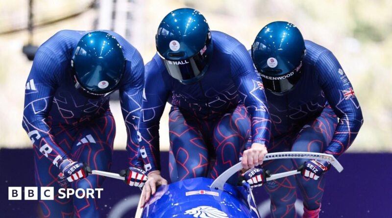 Team GB push the sled in the first heat of the bobsleigh at Cortina sliding centre