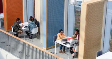 Groups of college students sitting in booths, discussing