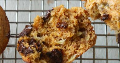 A halved chocolate banana muffin on a cooling rack.