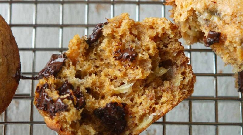 A halved chocolate banana muffin on a cooling rack.