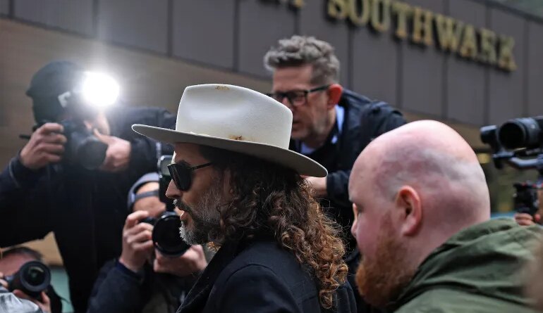 British comedian and actor Russell Brand arrives to attend a one-day plea and trial preparation hearing at Southwark Crown Court in south London on February 24, 2026. (Photo by Adrian DENNIS / AFP)