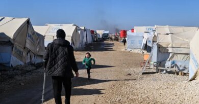 AL HASAKAH, SYRIA - JANUARY 26: Detainees are seen between tents at the al-Hol camp on January 26, 2026 in Al Hasakah, Syria. The al-Hol camp (also spelled Al-Hawl) in Syria's northeastern Hasakah province has come under control by Syrian government forces, following the withdrawal of the Kurdish-led Syrian Democratic Forces (SDF) in recent days. The camp houses around 24,000 people, many of whom are women and children, with alleged links to the jihadist group Islamic State (IS), also referred to as ISIS in the region. Clashes between the SDF and government forces this month over the former's integration with state institutions has seen large swaths of Kurdish-controlled territory ceded. Under a ceasefire agreement, camps and prisons housing ISIS detainees previously held by the US-backed Kurdish forces are to be transferred to the government. The United Nations (UN) has said it will take over management of al-Hol, resuming the delivery of humanitarian supplies to the camp, amid dire conditions. (Photo by Abdulmonam Eassa/Getty Images)