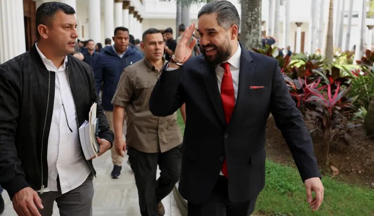 Nicolas Maduro Guerra walks with National Assembly members after discussions of an amnesty law
