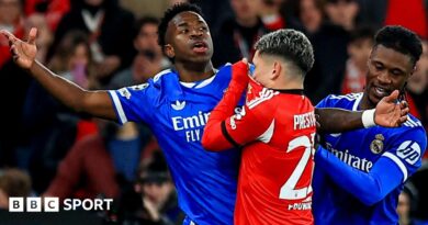 Real Madrid's Vinicius Junior reacts after an interaction with Benfica's Gianluca Prestianni