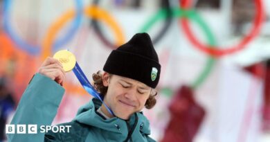 Lucas Pinheiro Braathen holds up his Olympic gold medal
