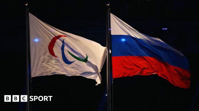 Paralympic flag and Russia flag flying side-by-side