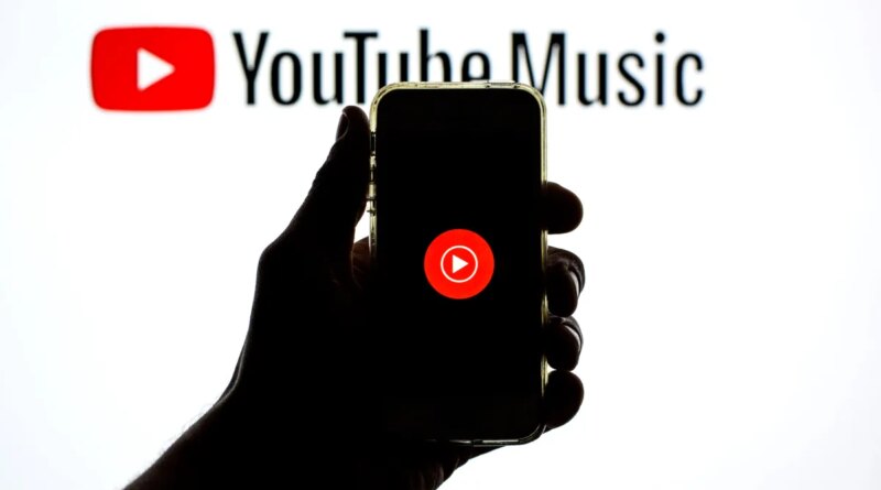 The YouTube Music app seen displayed on a smartphone screen and a YouTube Music logo in the background.