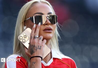 Alisha Lehmann in sunglasses and a red shirt