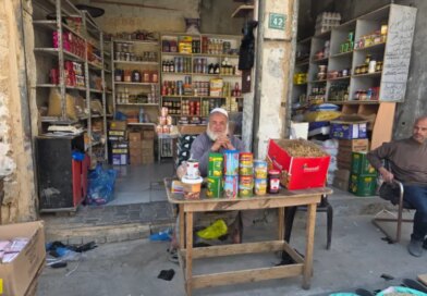 Nahed Barbakh, 60, shop owner and trader, sits at a table in front of his store