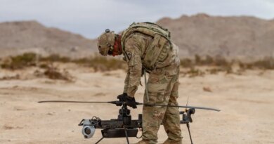 A US soldier prepares an Anduril-built drone for flight during a training exercise.