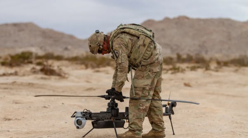 A US soldier prepares an Anduril-built drone for flight during a training exercise.