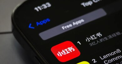 A smartphone screen displays the RedNote app (Xiaohongshu) ranking first in the Free Apps category on the App Store