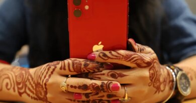 red iPhone held in two hands