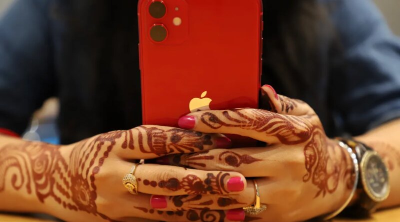 red iPhone held in two hands