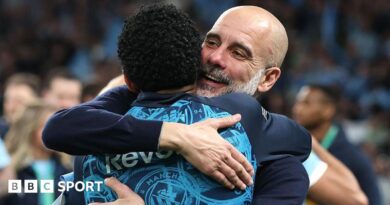 Pep Guardiola hugs his players