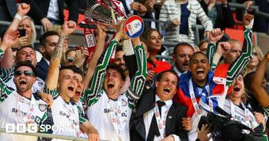 Sunderland players celebrate by lifting the Championship play-off final trophy at Wembley in May 2025