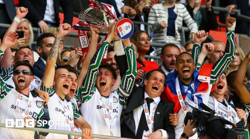 Sunderland players celebrate by lifting the Championship play-off final trophy at Wembley in May 2025