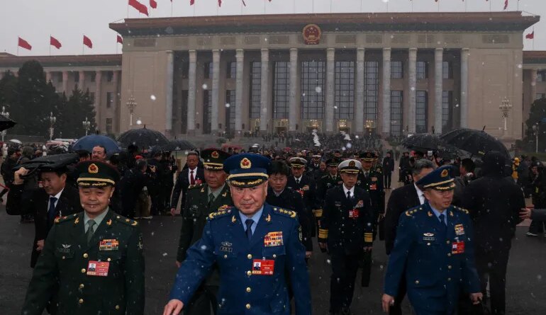 Members of the Chinese People's Liberation Army (PLA) leave the Great Hall of the People amid snowfall on Tiananmen Square, before the opening sessions of the annual Chinese People's Political Consultative Conference (CPPCC) and National People's Congress (NPC), in Beijing, China, March 4, 2026. REUTERS/Tingshu Wang