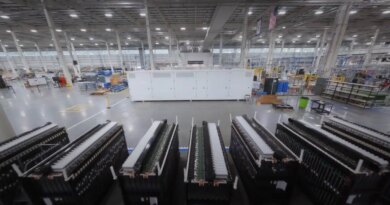 A big battery sits inside a factory.