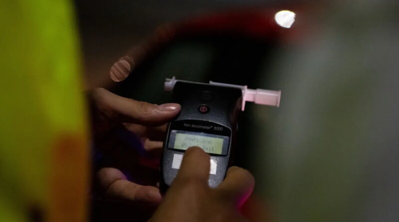 A police officer administers a breathalyser breath alcohol test after stopping a driver, on December 02, 2022 in Bournemouth, England.