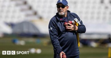 Darren Lehmann prepares to catch a cricket ball while wearing a baseball mitt