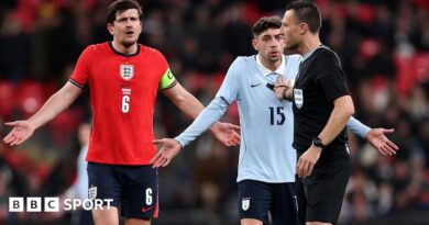 Harry Maguire of England and Federico Valverde of Uruguay react towards referee Sven Jablonski