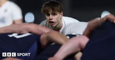 Lucas Friday kicking the ball against Scotland