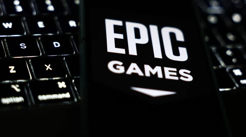 A laptop keyboard and Epic Games logo displayed on a phone screen are seen in this illustration photo taken in Krakow, Poland on October 1, 2024. (Photo by Jakub Porzycki/NurPhoto via Getty Images)