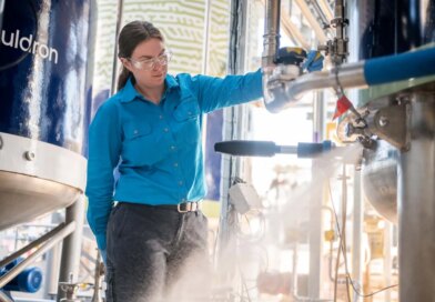A woman operates a fermenter.