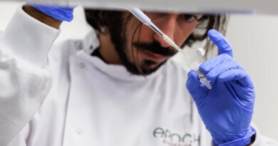 A man pipettes a liquid into a small tube.