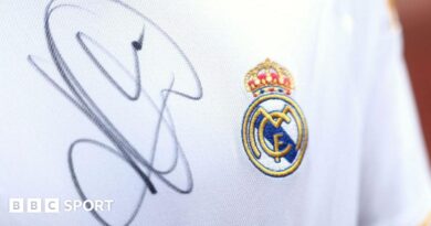 A close up image of a Real Madrid shirt signed by Kylian Mbappe