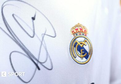 A close up image of a Real Madrid shirt signed by Kylian Mbappe