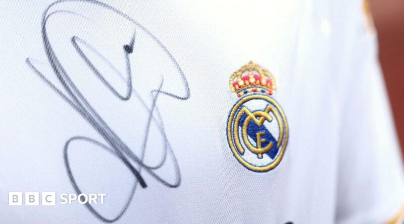 A close up image of a Real Madrid shirt signed by Kylian Mbappe