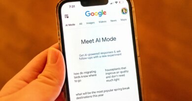 A person holding an iPhone and using Google AI Mode