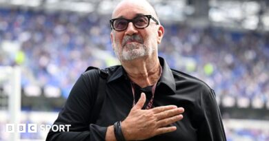 Designer Dan Meis applauds Everton fans at their first home match in their new stadium.