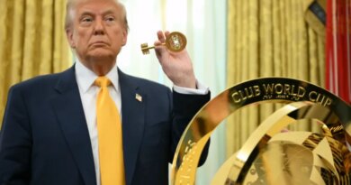 Trump holds up a key in front of the FIFA Club Cup Trophy