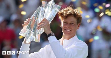 Jannik Sinner holds the trophy in celebration after winning the Indian Wells title