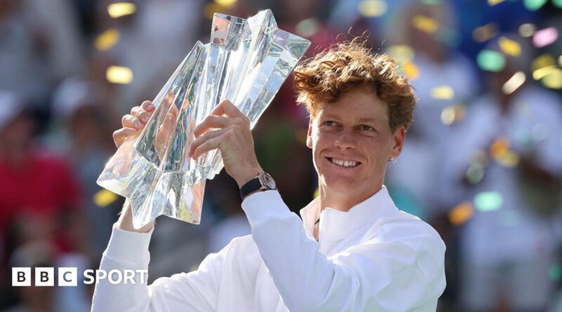 Jannik Sinner holds the trophy in celebration after winning the Indian Wells title