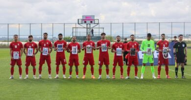 Iran players in Turkey pose with photos of young war victims