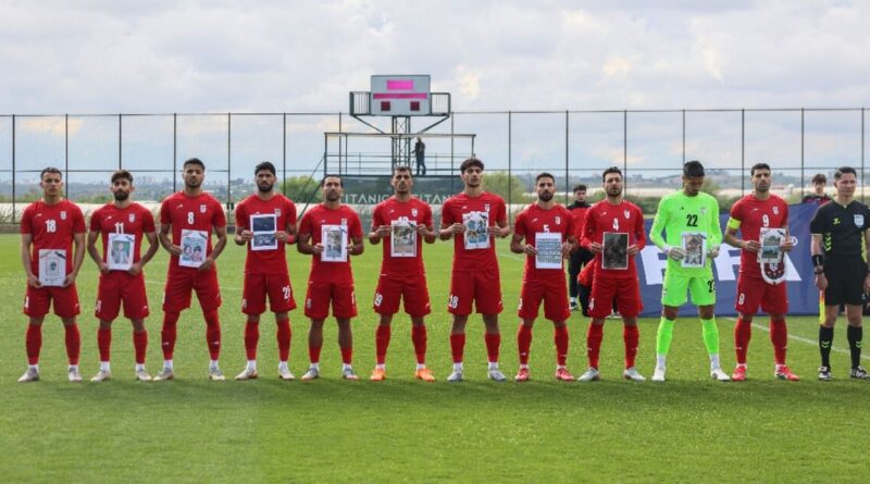 Iran players in Turkey pose with photos of young war victims