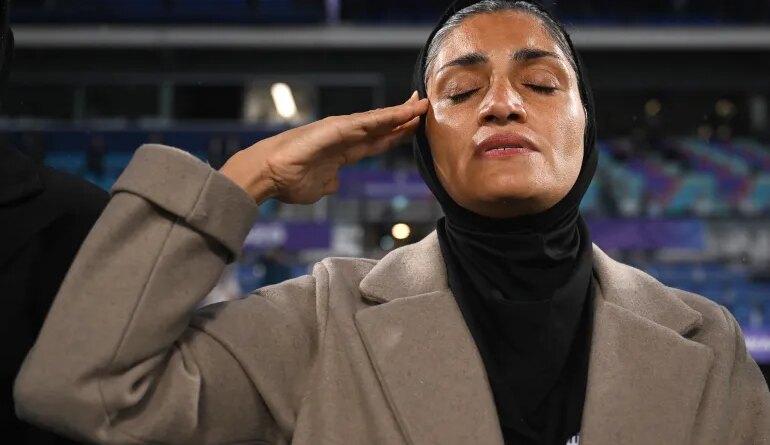 Iran coach Marziyeh Jafari salutes during the national anthem ahead of the Women's Asian Cup soccer match between Iran and the Philippines in Robina, Australia, Sunday, March 8, 2026. (Dave Hunt/AAP Image via AP)