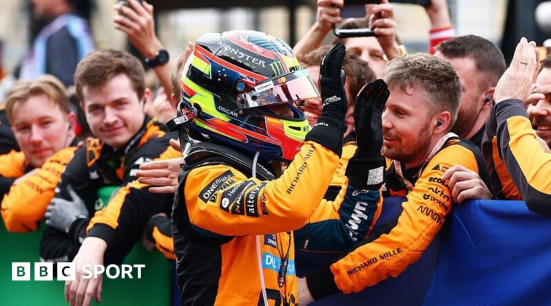 Oscar Piastri gives high fives to his McLaren team members after coming second at Suzuka