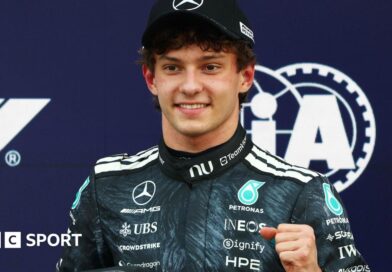 Kimi Antonelli is presented with his pole position award by Japanese sumo wrestler Kotozakura Masakatsu II 