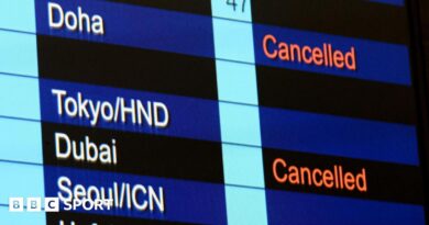 Cancelled flights to Dubai and Doha shown on flight information display at Hong Kong International Airport