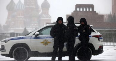 Russian Police officers walk during a snowstorm at Red Square, on February 16, 2026, in Moscow, Russia.