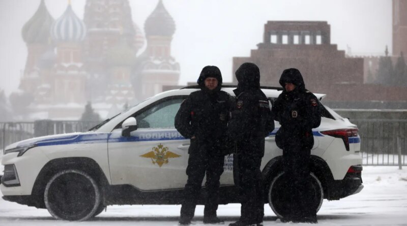 Russian Police officers walk during a snowstorm at Red Square, on February 16, 2026, in Moscow, Russia.