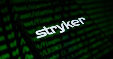 The Stryker Corporation logo appears on the screen of a smartphone
