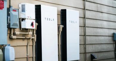 Two Tesla Powerwalls sit on the outside of a house.