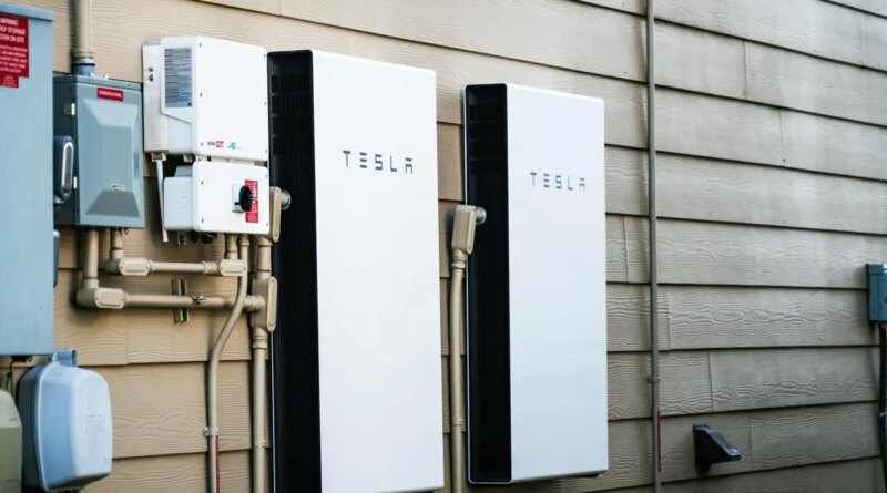Two Tesla Powerwalls sit on the outside of a house.