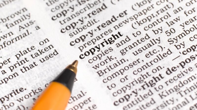 A pencil pointing to the word copyright in a dictionary